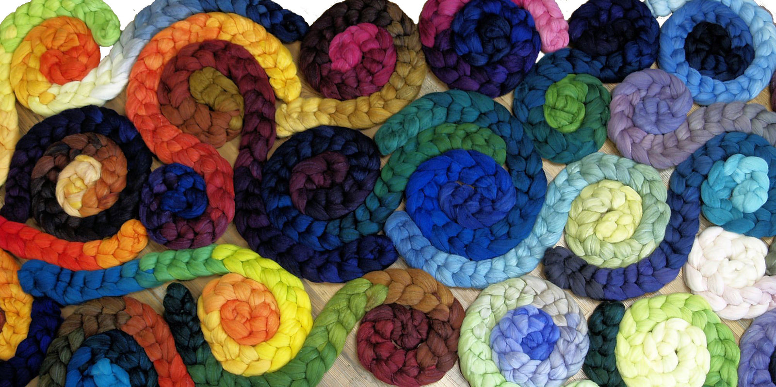 A collage of Fiber Optic Yarns hand dyed gradient spinning fiber, showing how the colors integrate with one another.